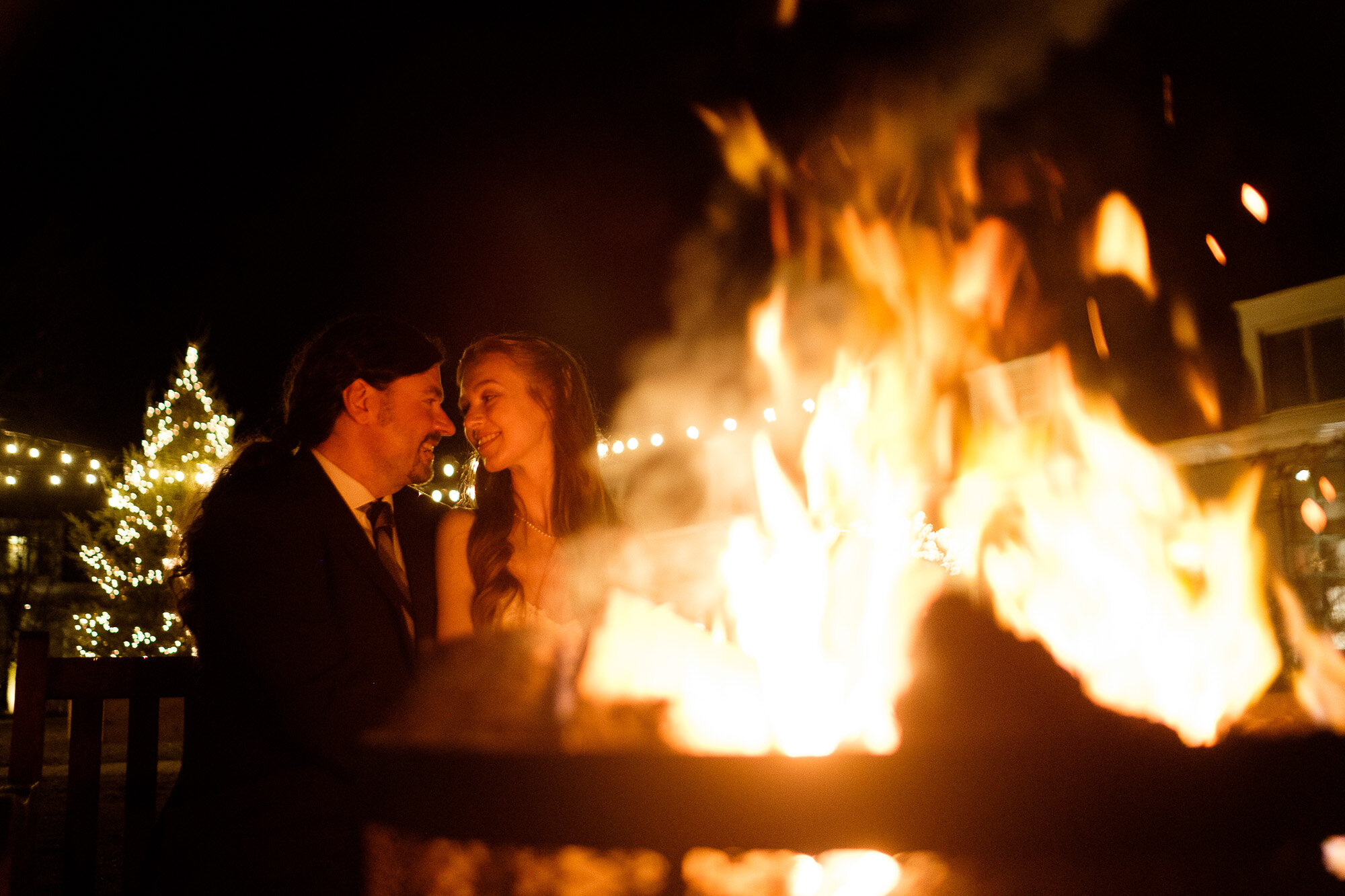  A night time wedding portrait of Laura + Raymond as they pose by the open fire at Langdon Hall after their intimate winter wedding.  Wedding Photograph by Toronto wedding photographer Scott Williams (www.scottwilliamsphotographer.com) 
