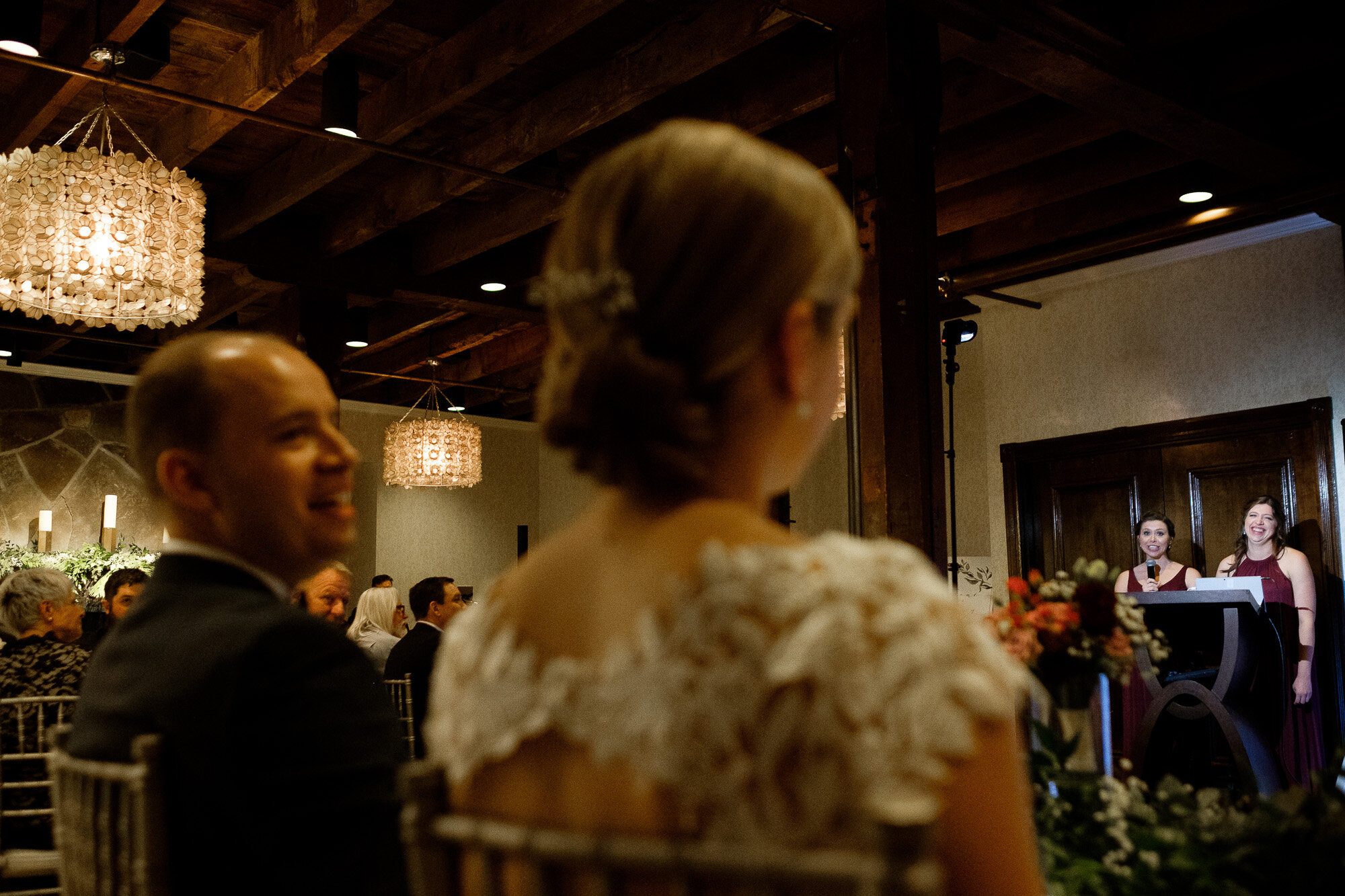  Lisa + Tyler react to Lisa’s sisters giving them a wedding toast during their wedding reception at the Ancaster Mill in Ancaster, Ontario.   Wedding photograph by Toronto wedding photographer Scott Williams (www.scottwilliamsphotographer.com) 