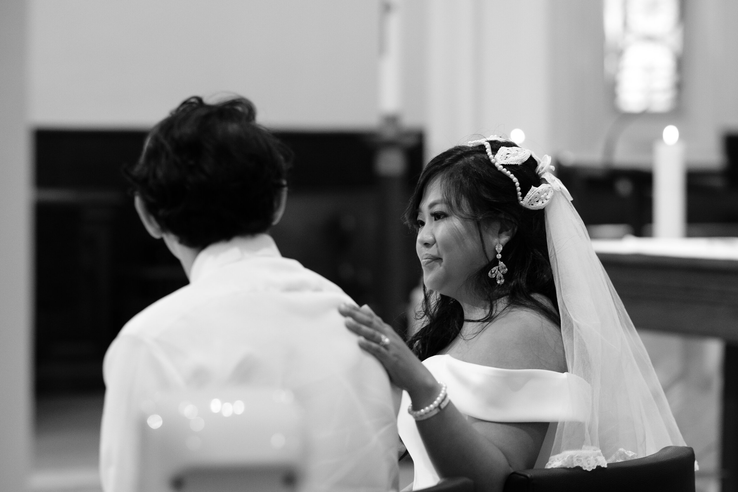  A detail black and white candid wedding photograph of the bride and groom sharing a moment during the Catholic wedding ceremony of  Geraldine &amp; Raphael’s backyard Toronto wedding by Toronto documentary wedding photographer Scott Williams (www.sc