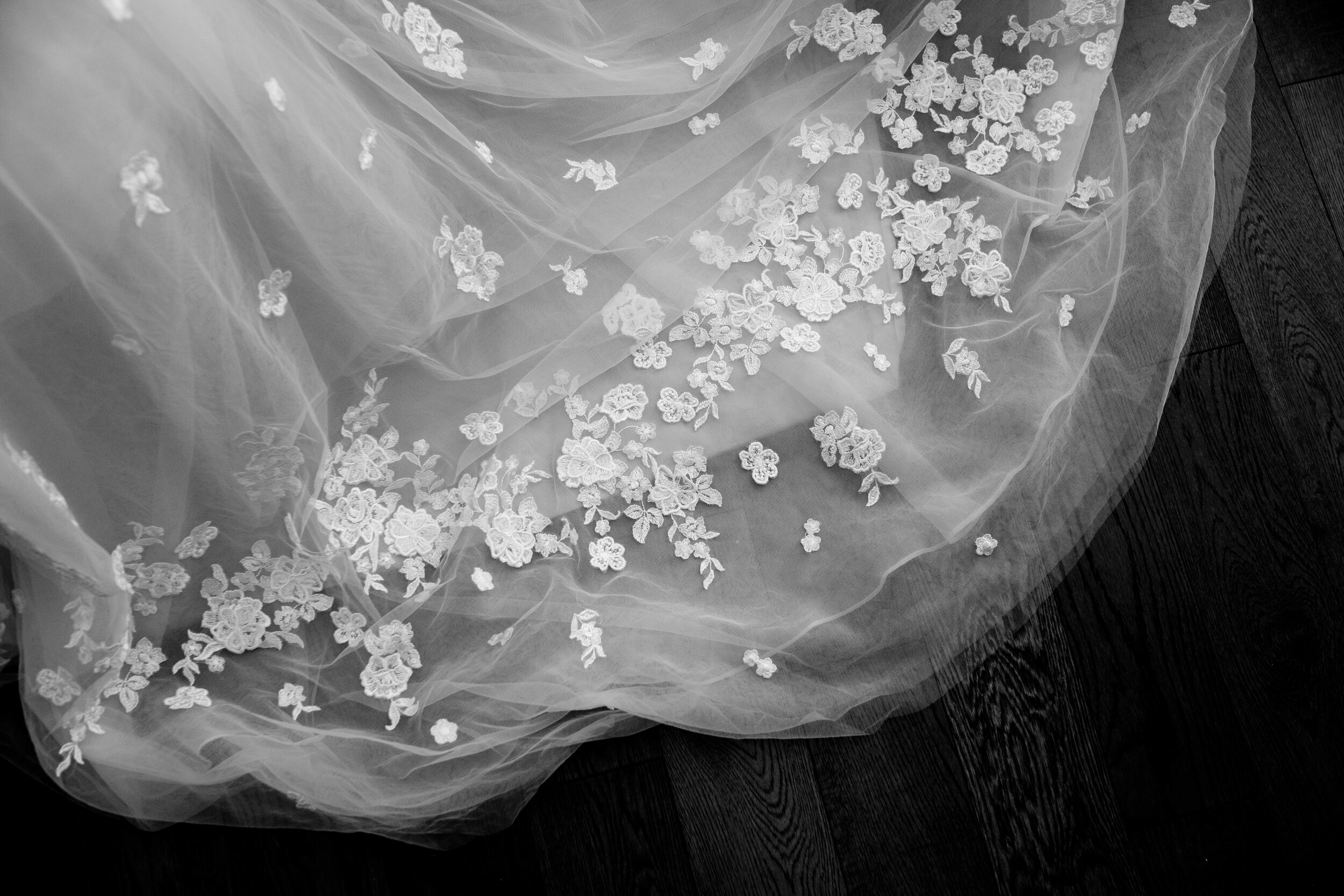  A black and white detail photograph of the brides wedding dress before her outdoor wedding at Langdon Hall in Cambridge, Ontario by Toronto wedding photographer Scott Williams (www.scottwilliamsphotogrpaher.com) 