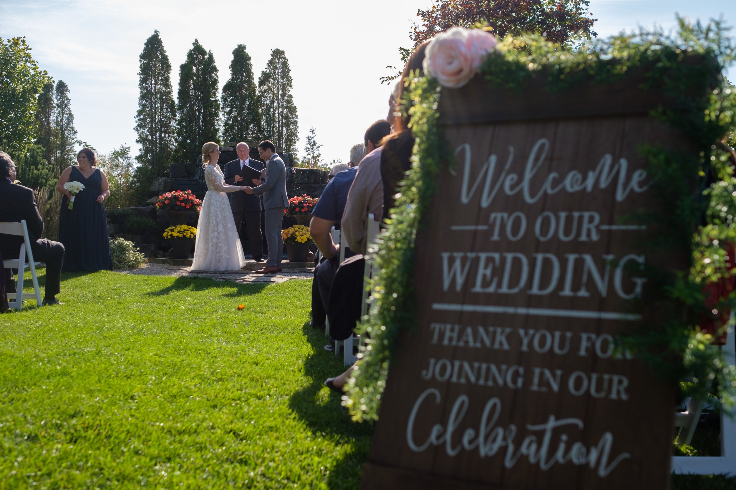  A candid colour wedding photograph during the outdoor wedding ceremony of  Cassandra and Antony’s wedding at the Hessenland Inn by Toronto wedding photographer Scott Williams. 