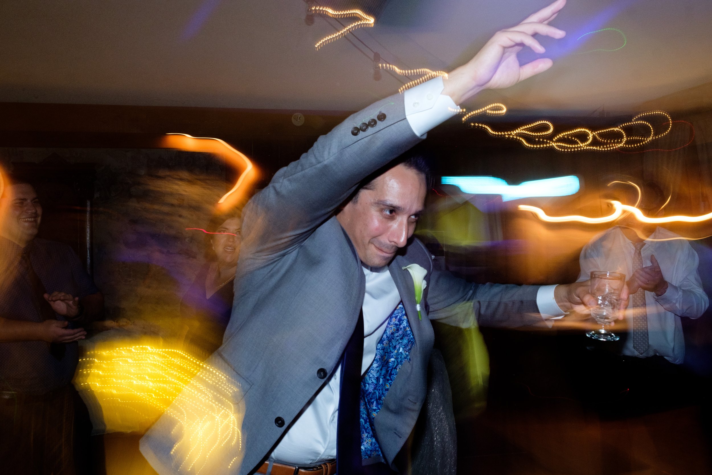  A candid colour wedding photograph of the groom on the dance floor during the reception at  Cassandra and Antony’s wedding at the Hessenland Inn by Toronto wedding photographer Scott Williams. 