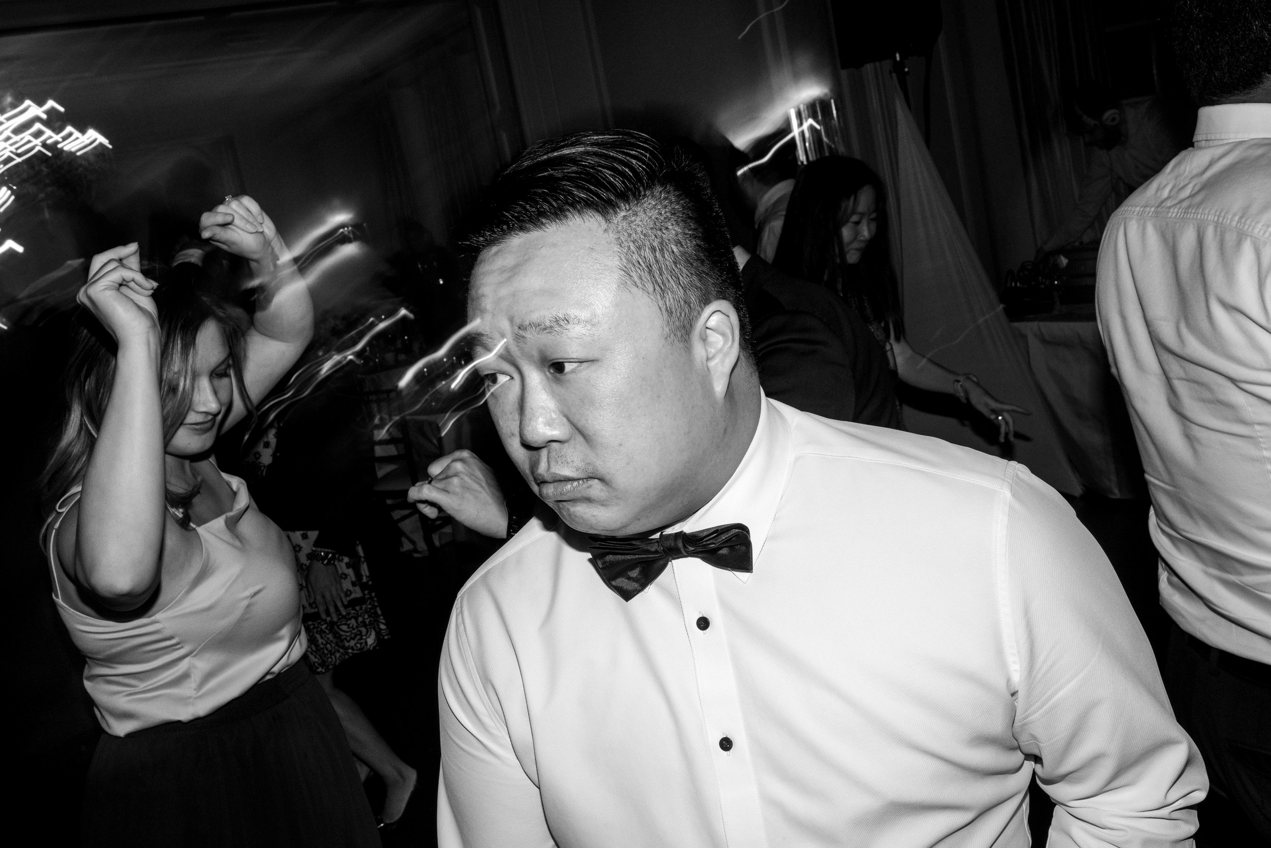  A candid wedding photograph of of a guest dancing during the wedding reception later at Graydon Hall in Toronto, Ontario.  Photograph by Toronto Wedding Photographer Scott Williams.  