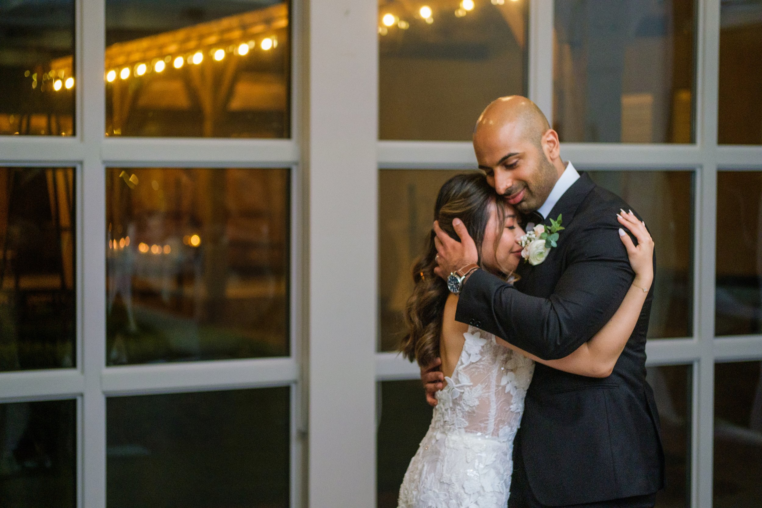  A colour candid wedding photograph as the couple enjoy their first dance during the reception from Tiffany + Zoubin’s wedding at Langdon Hall by Toronto Wedding Photographer Scott Williams  