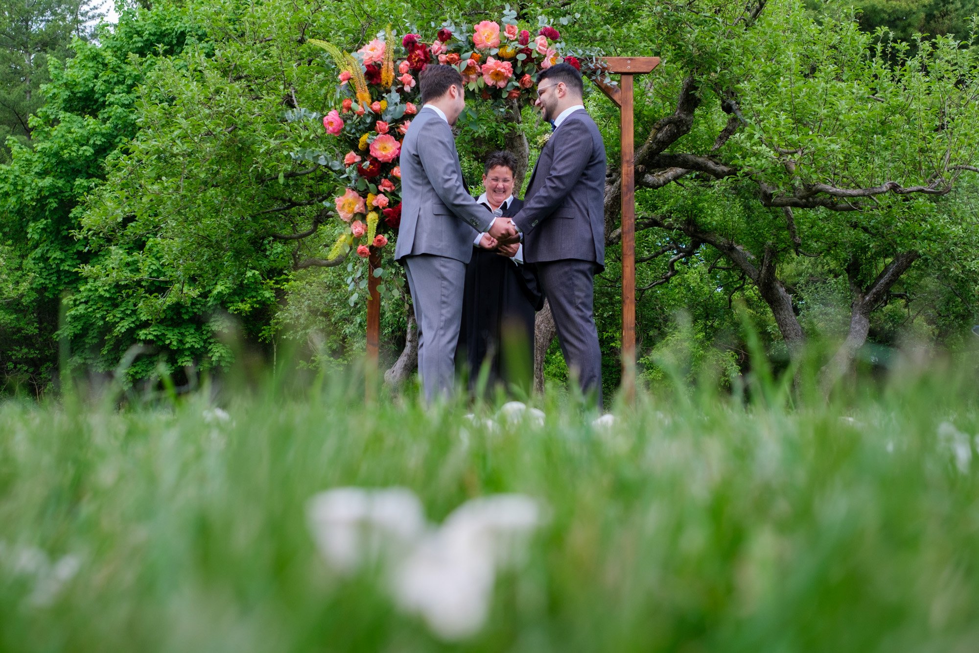  A colour candid wedding photograph of Greg and Damon’s wedding ceremony on the grounds of Langdon Hall   Photograph by Toronto wedding photographer Scott Williams (www.scottwilliamsphotographer.com) 