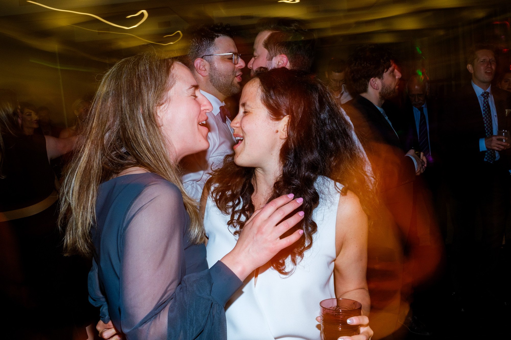  A colour candid wedding photograph of Greg and Damon’s reception as guests dance the night away in the Firshade Room in Langdon Hall   Photograph by Toronto wedding photographer Scott Williams (www.scottwilliamsphotographer.com) 