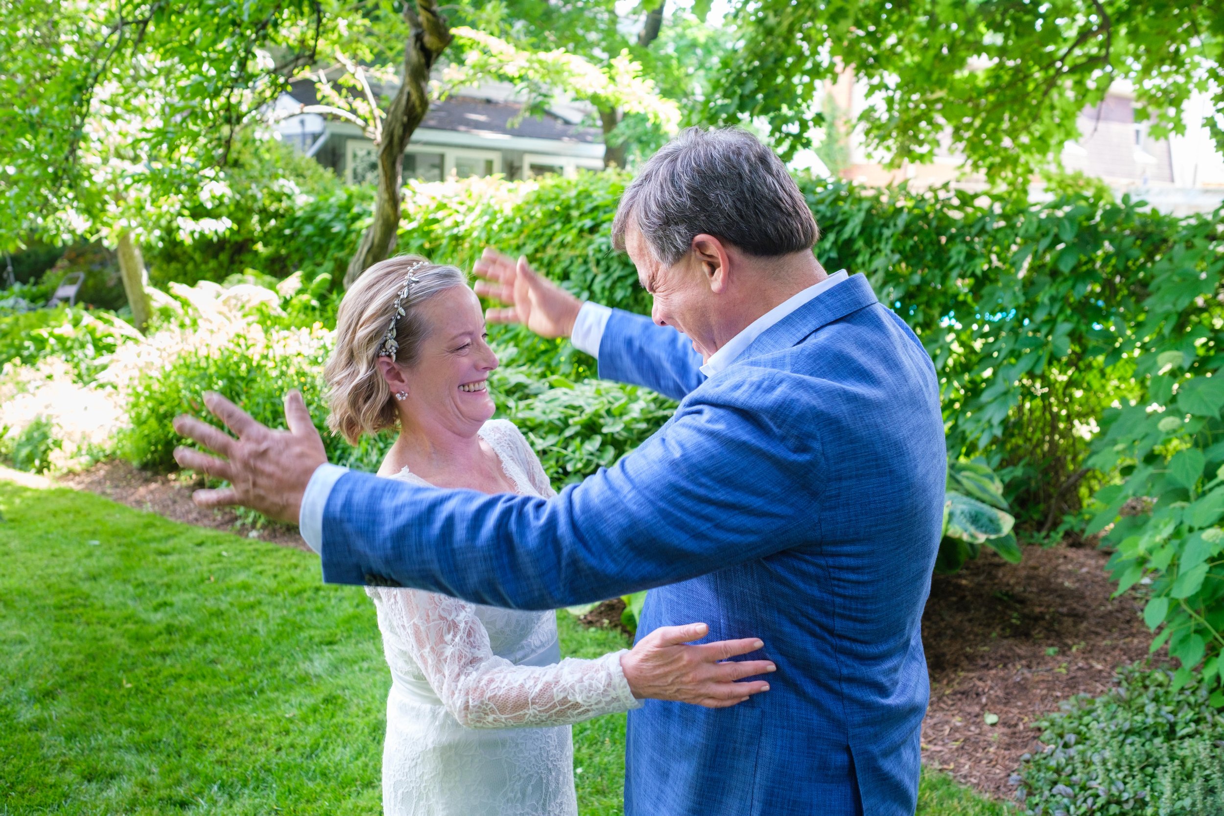  A colour candid wedding photograph from Katherine + Cameron’s first look during their intimate backyard wedding in Waterloo, Ontario by Toronto wedding photographer Scott Williams (www.scottwilliamsphotographer.com) 