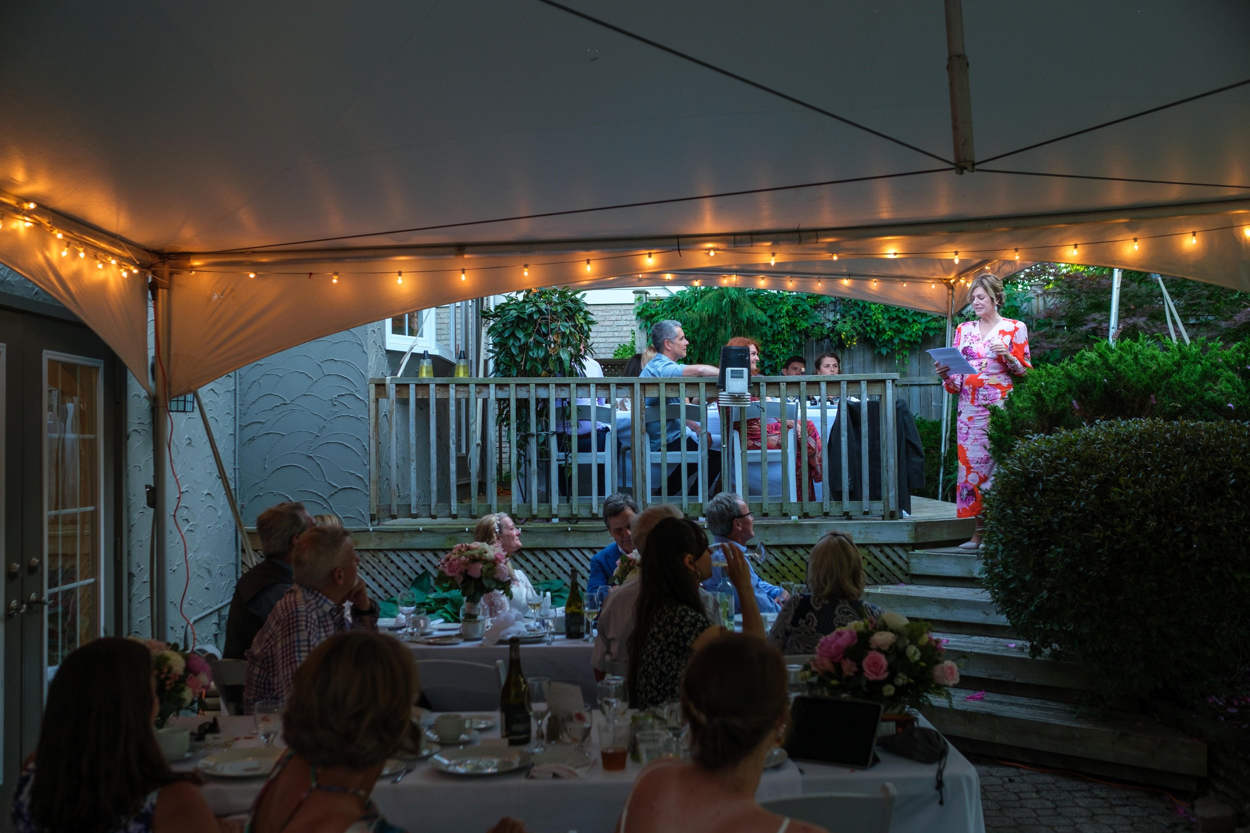  A colour candid wedding photograph from Katherine + Cameron’s dinner reception during their backyard wedding in Waterloo, Ontario by Toronto wedding photographer Scott Williams (www.scottwilliamsphotographer.com) 