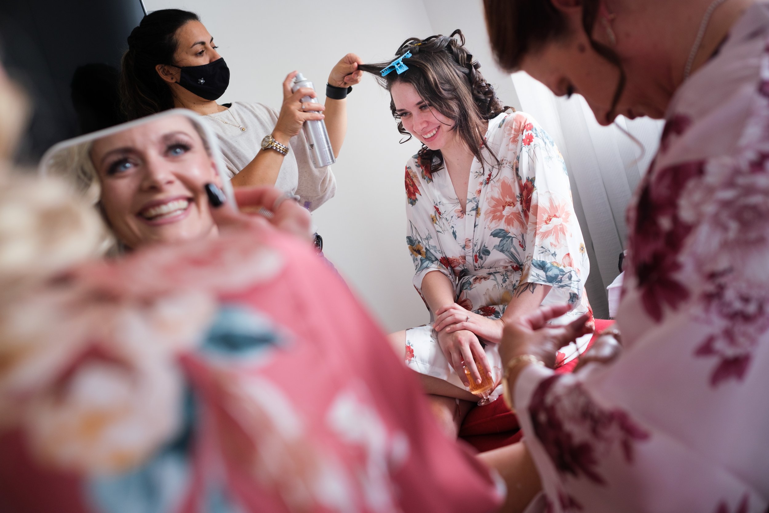  A candid color wedding photograph from Megan + Josh’s Kitchener wedding at The Museum.  The bride is getting her hair done in her suite at the Walper Hotel in Kitchener by Toronto Wedding photographer Scott Williams (www.scottwilliamsphotographer.co