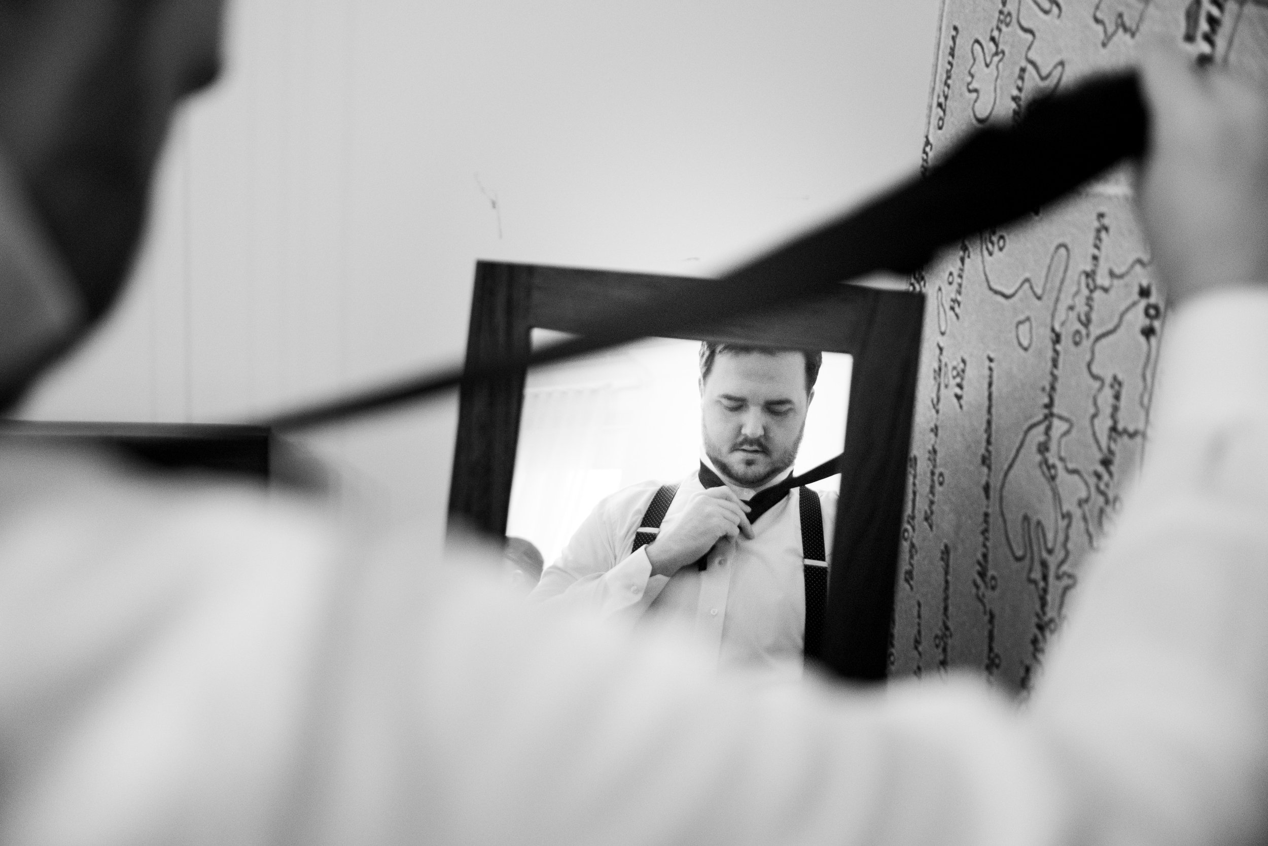  A candid black and white  wedding photograph from Megan + Josh’s Kitchener wedding at The Museum.  The groom is getting ready in his suite at the Walper Hotel in Kitchener by Toronto Wedding photographer Scott Williams (www.scottwilliamsphotographer