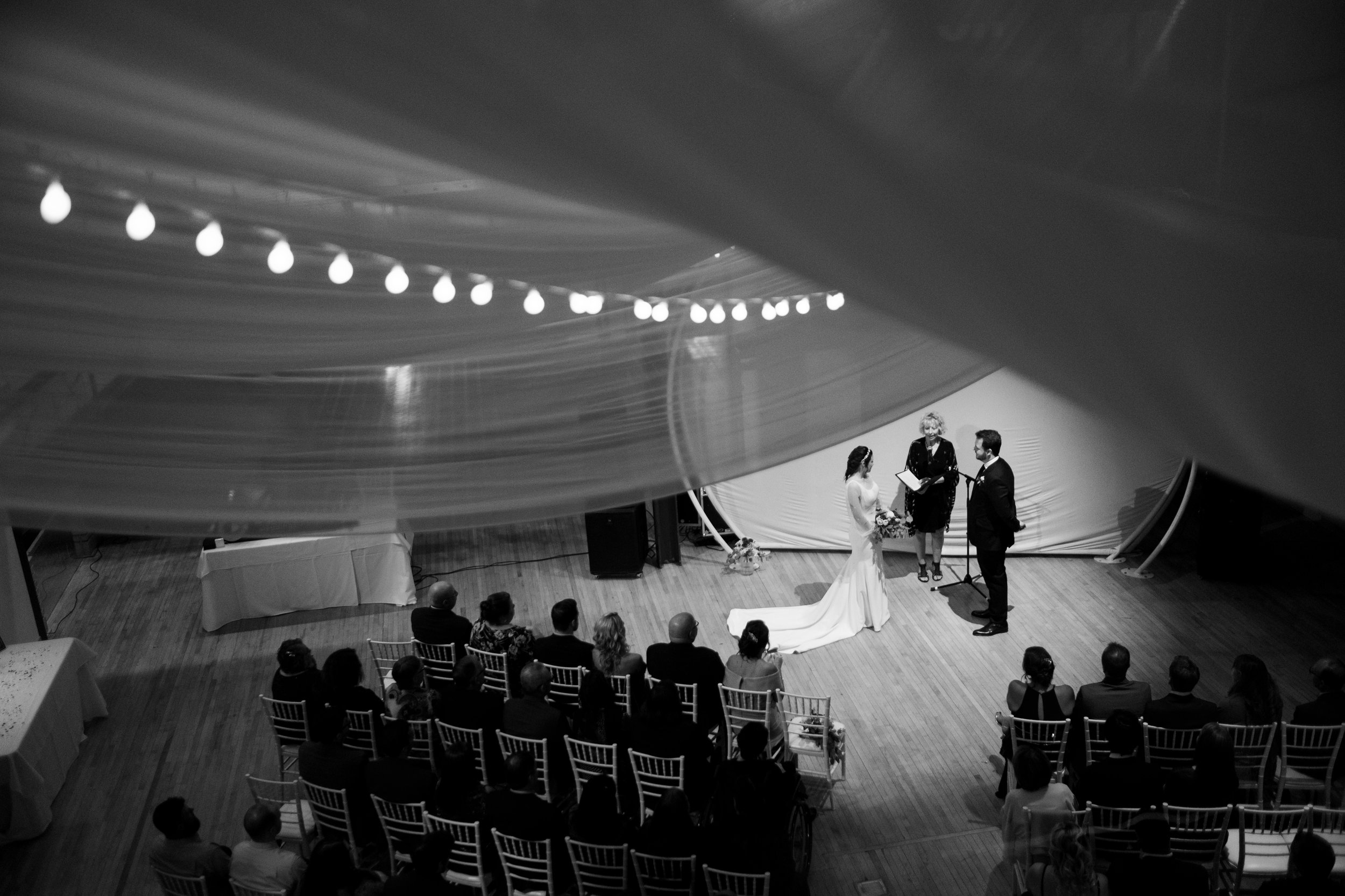  A black and white candid wedding photograph  from Megan + Josh’s Kitchener wedding during the ceremony at The Museum in Kitchener, Ontario by Toronto Wedding photographer Scott Williams (www.scottwilliamsphotographer.com) 