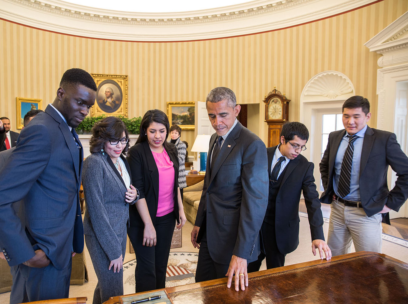 President Barack Obama shows the Resolute Desk to young immigrants while giving them an Oval Office tour. The President met with the group of DREAMers, who talked about how they have benefited from Deferred Action for Childhood Arrivals, Feb. 4, 2015. (Official White House Photo by Pete Souza)