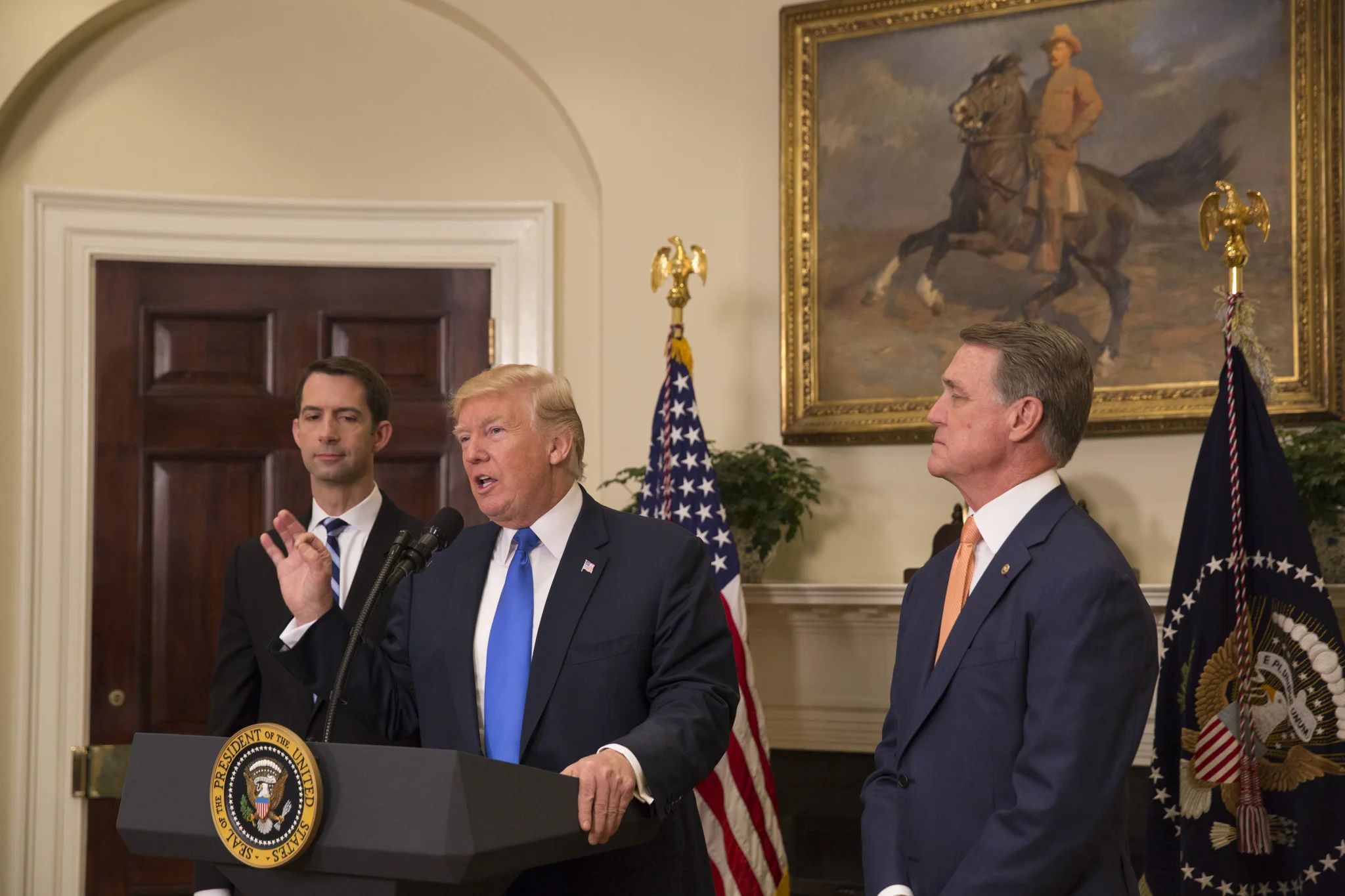 President_Donald_J._Trump,_Senator_Tom_Cotton,_and_Senator_David_Perdue,_August_2,_2017_(36182228582).jpg
