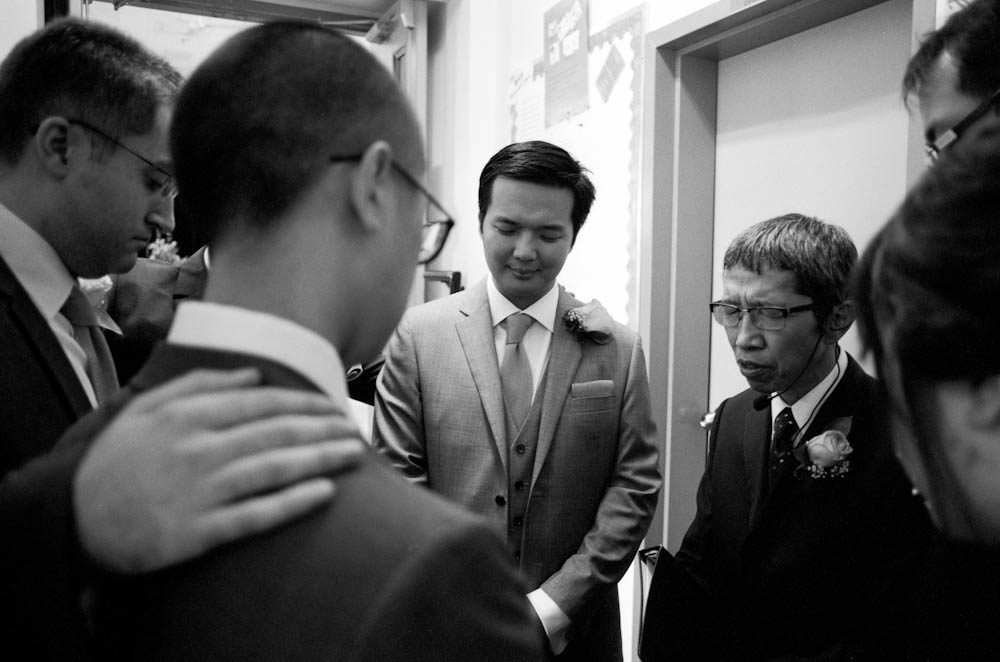 A moment of prayer just before Holman and his groomsmen step onto the altar and await the arrival of the bride.