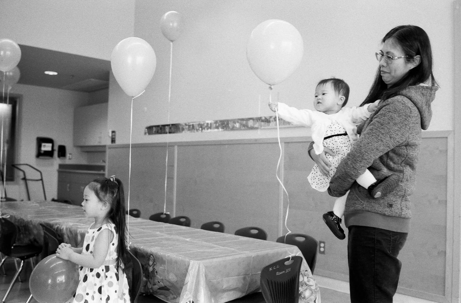 Here you can see Hannah (a little more grown up) and baby Abigail on the right waving around a balloon.