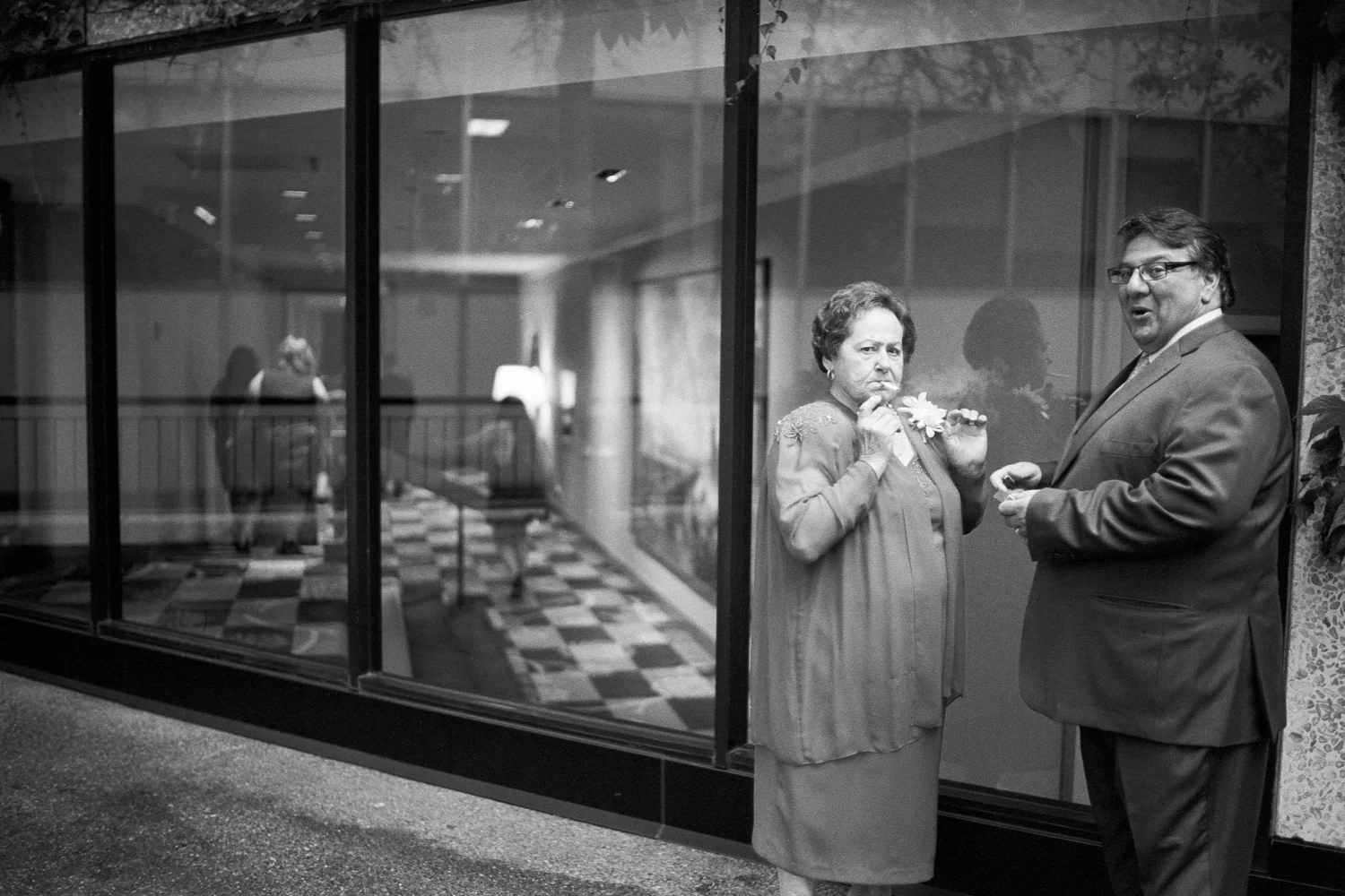 One of my favorite moments of 2015 :) We had just finished a request for a family group photograph and I saw these two starting to light up a cigarette. As I was walking towards the door, I quickly aligned my camera settings, set focus and clicked the shutter JUST as they saw me taking their photograph.