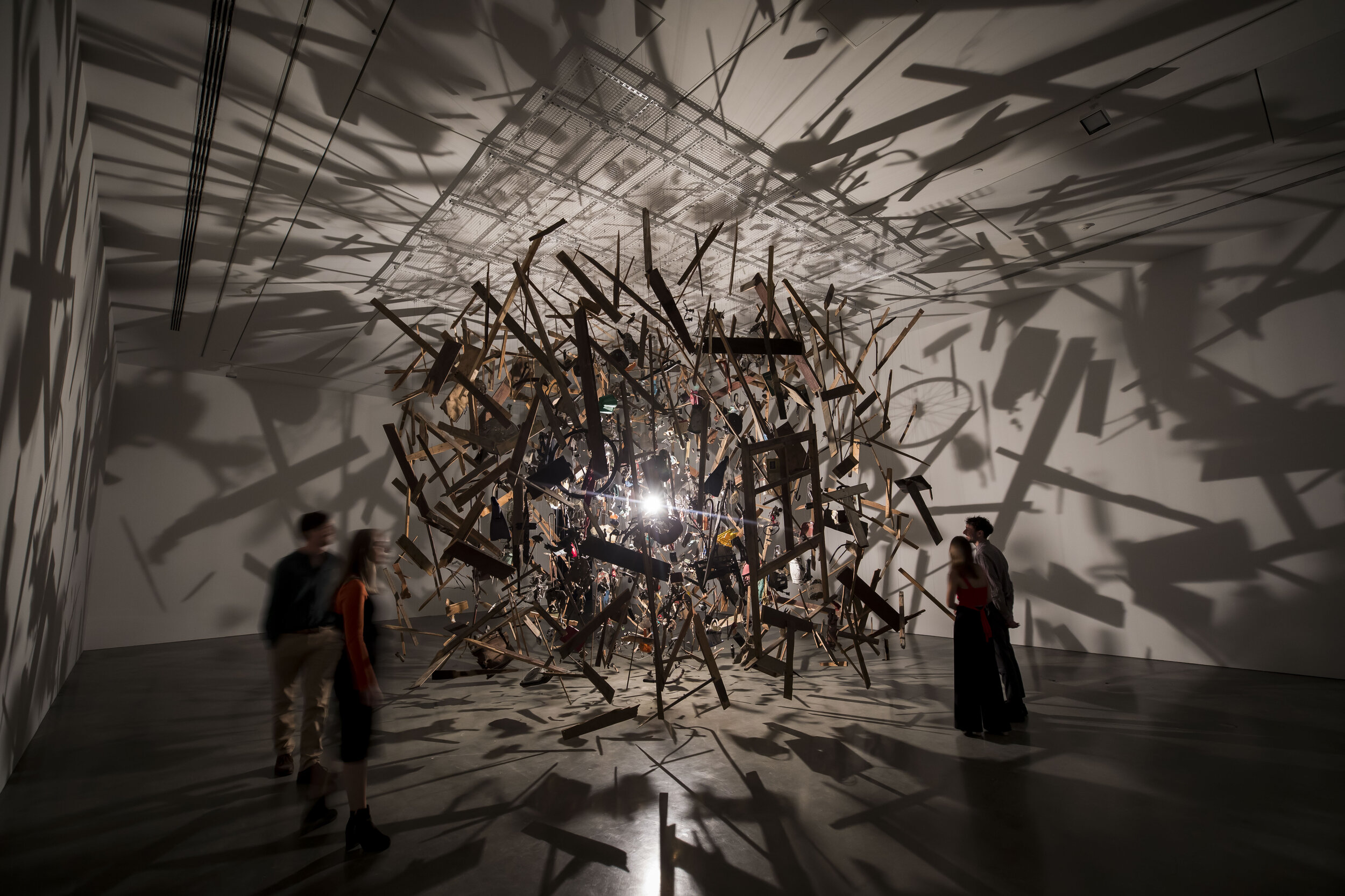 Visitors move through Cornelia Parker's artwork, 'Cold Dark Matter: An Exploded View', MCA