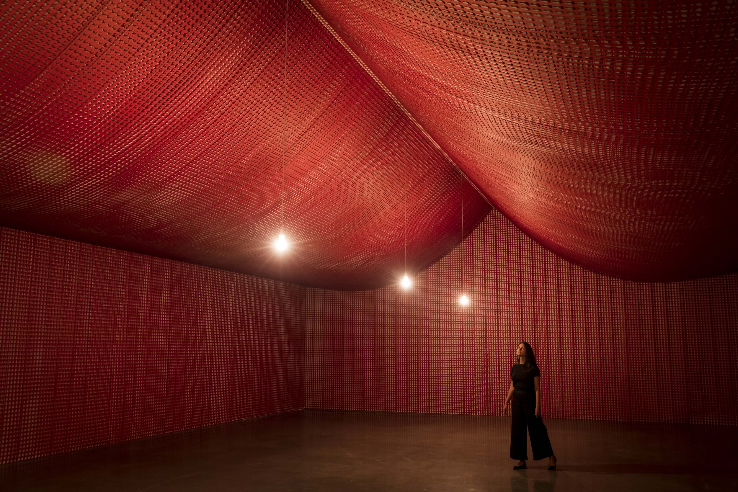 Visitor moves through Cornelia Parker's artwork, 'War Room', MCA