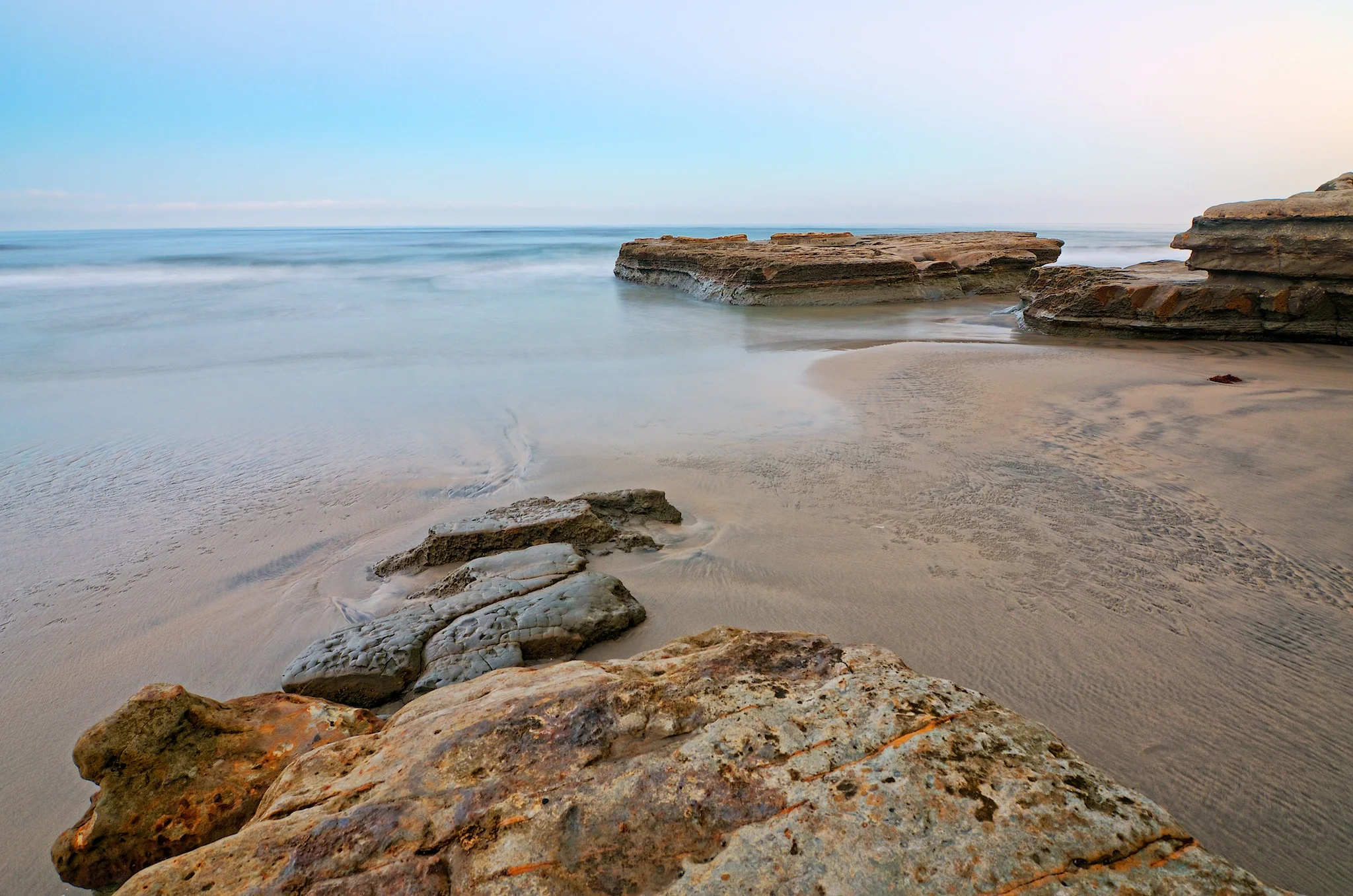 Shot 2 / Camera angled downward toward foreground rocks