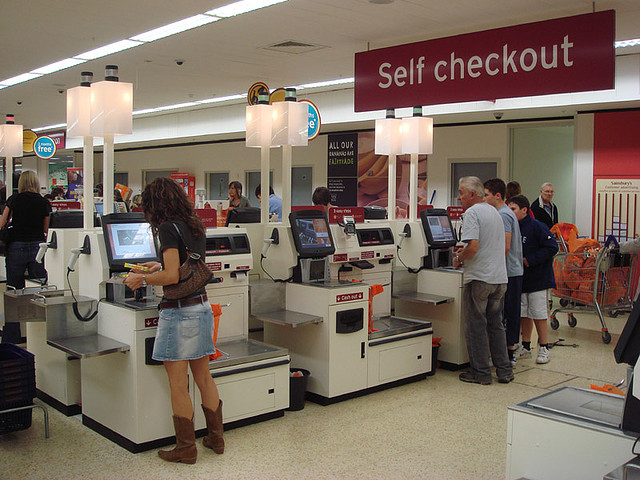 Self-checkouts (source: Wikimedia Commons )