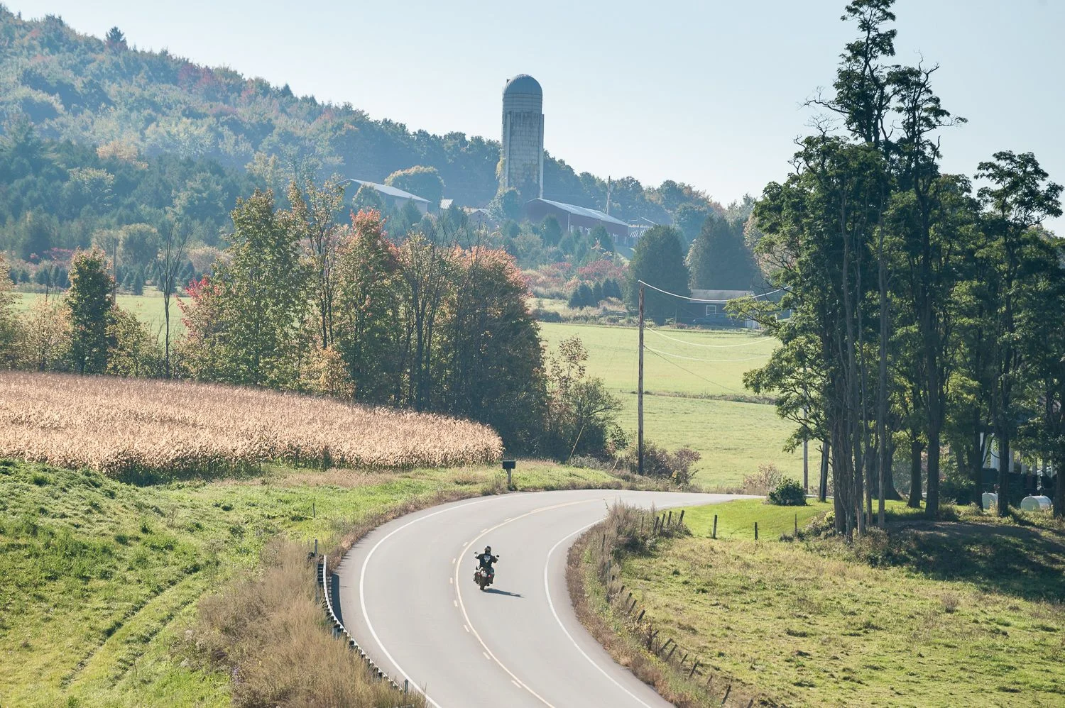 A lone rider rounds a corner on a fall morning on VT-116. Photo by Bob LoCicero