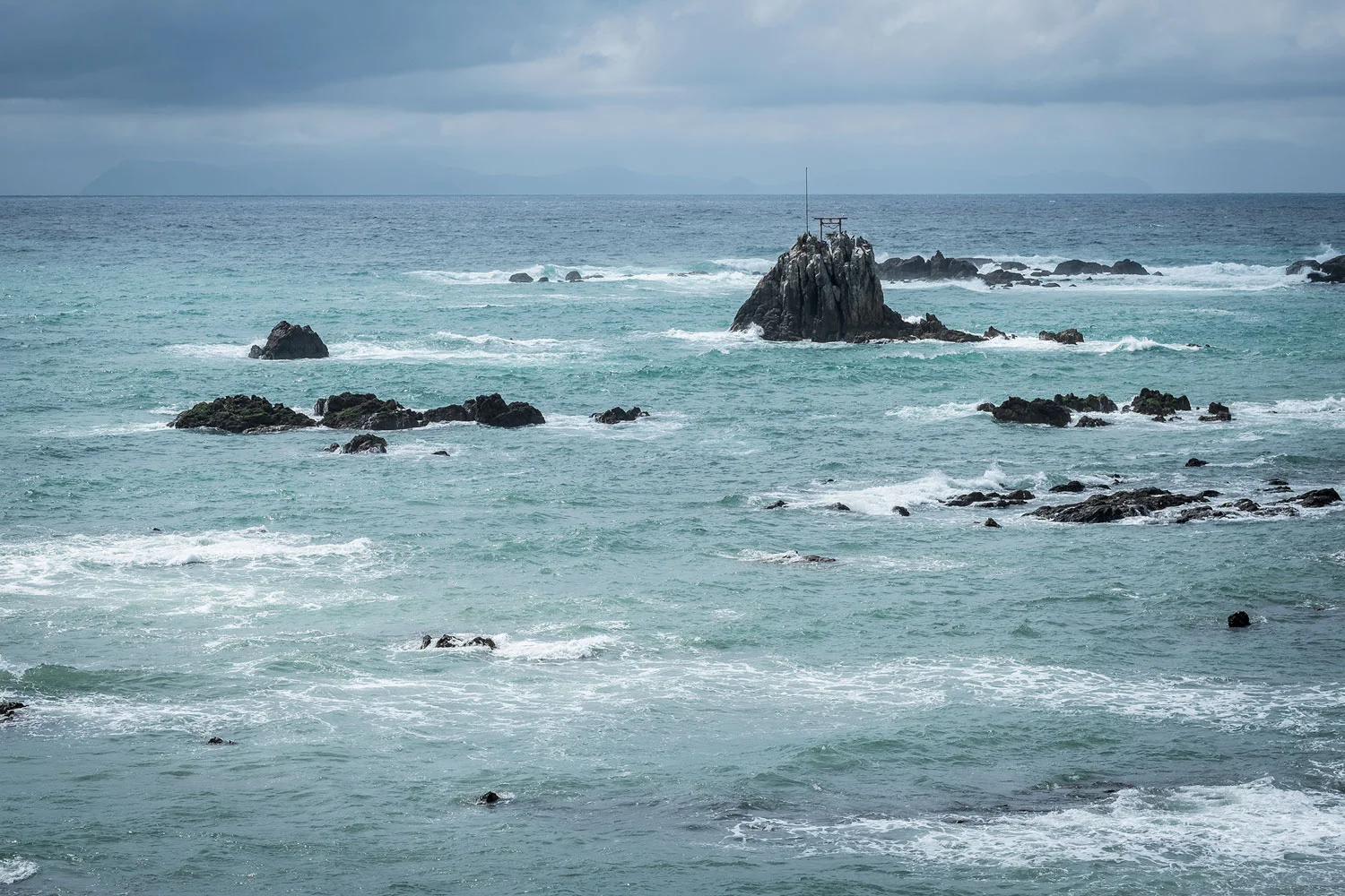A little Torii in the middle of the sea. 