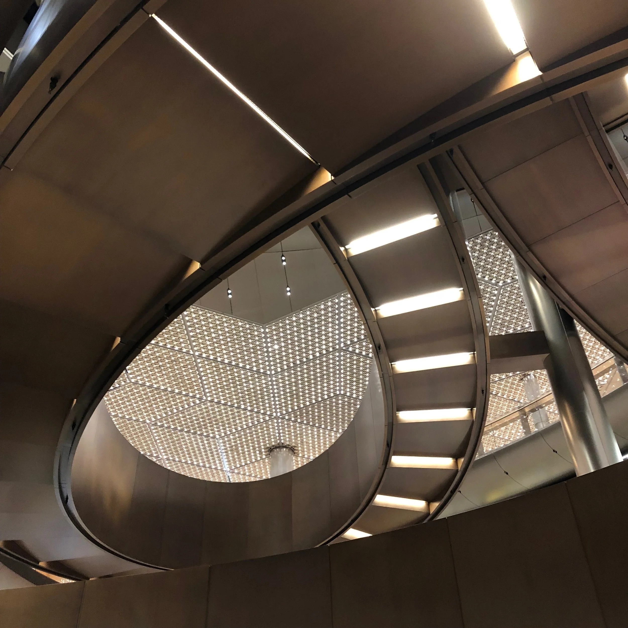 Brass staircase spiralling through the core of the building.