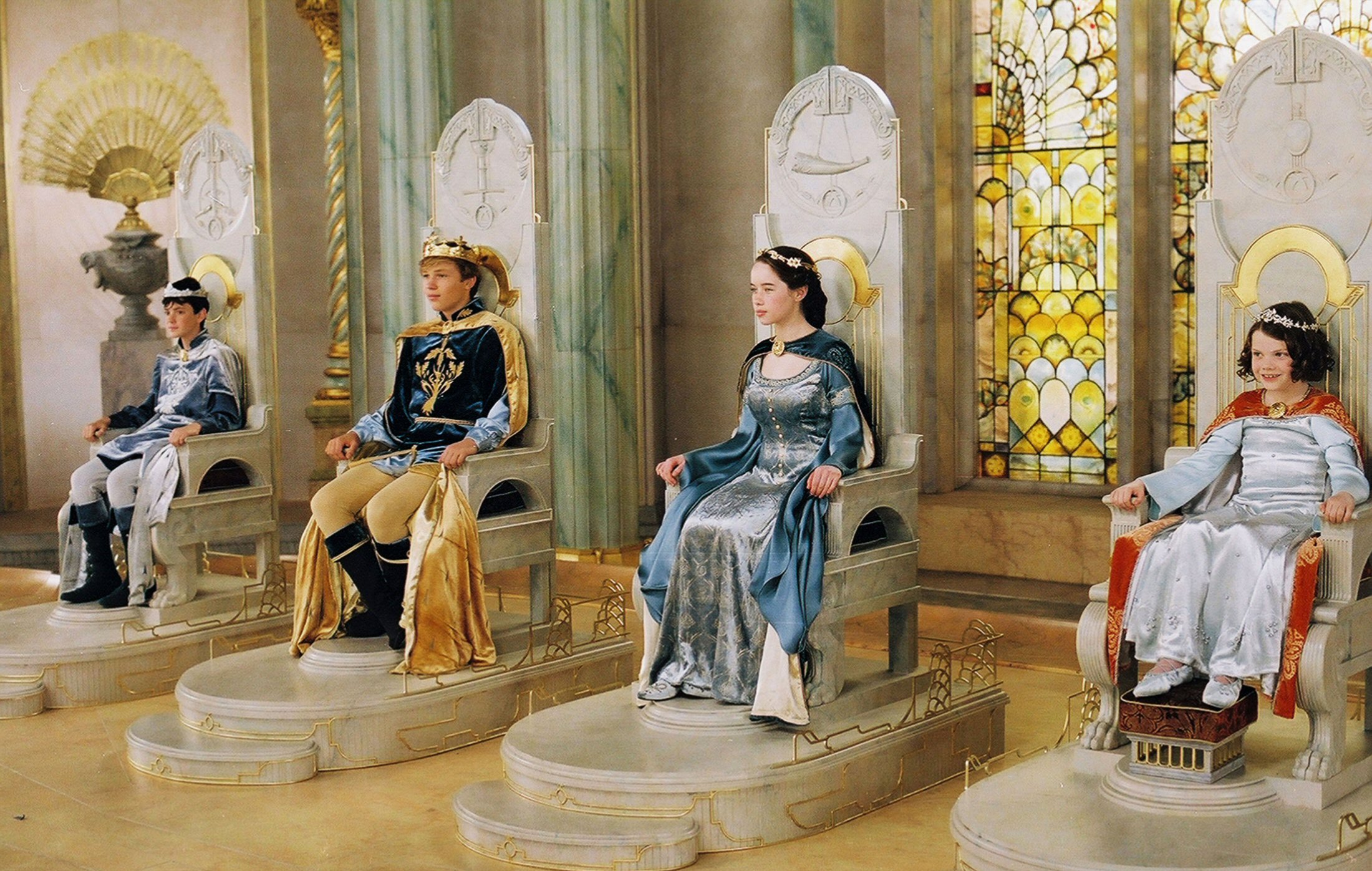 High King Peter, King Edmund, Queen Susan, and Queen Lucy at their coronation, at Cair Paravel in throne