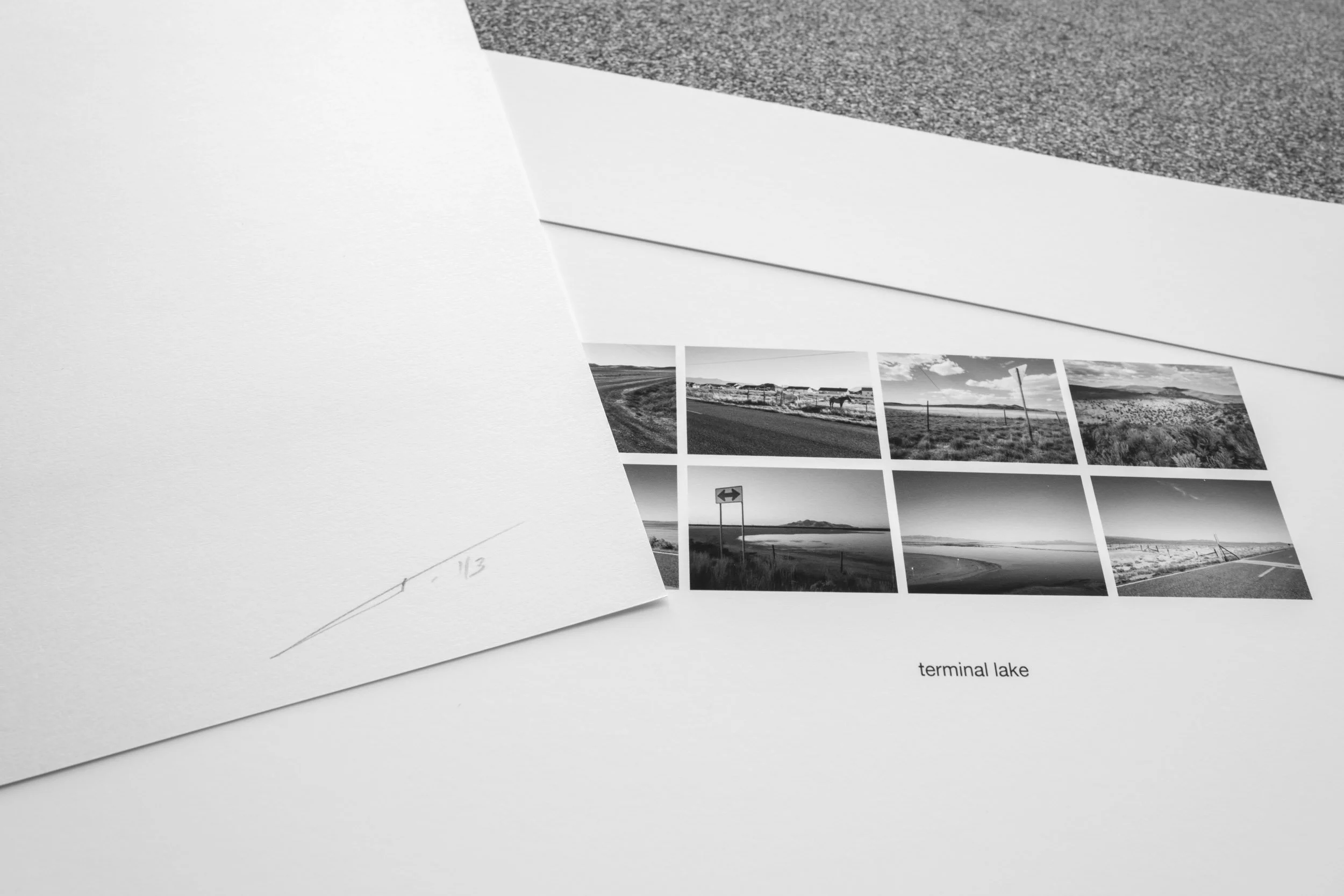 Photographs of scenic landscapes and a handwritten note on white and gray textured papers.