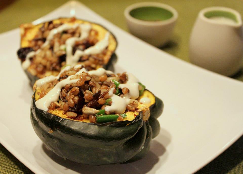 Acorn squash stuffed with barley, wild rice, scallions, dried cherries, za'atar spices and drizzled with tahini