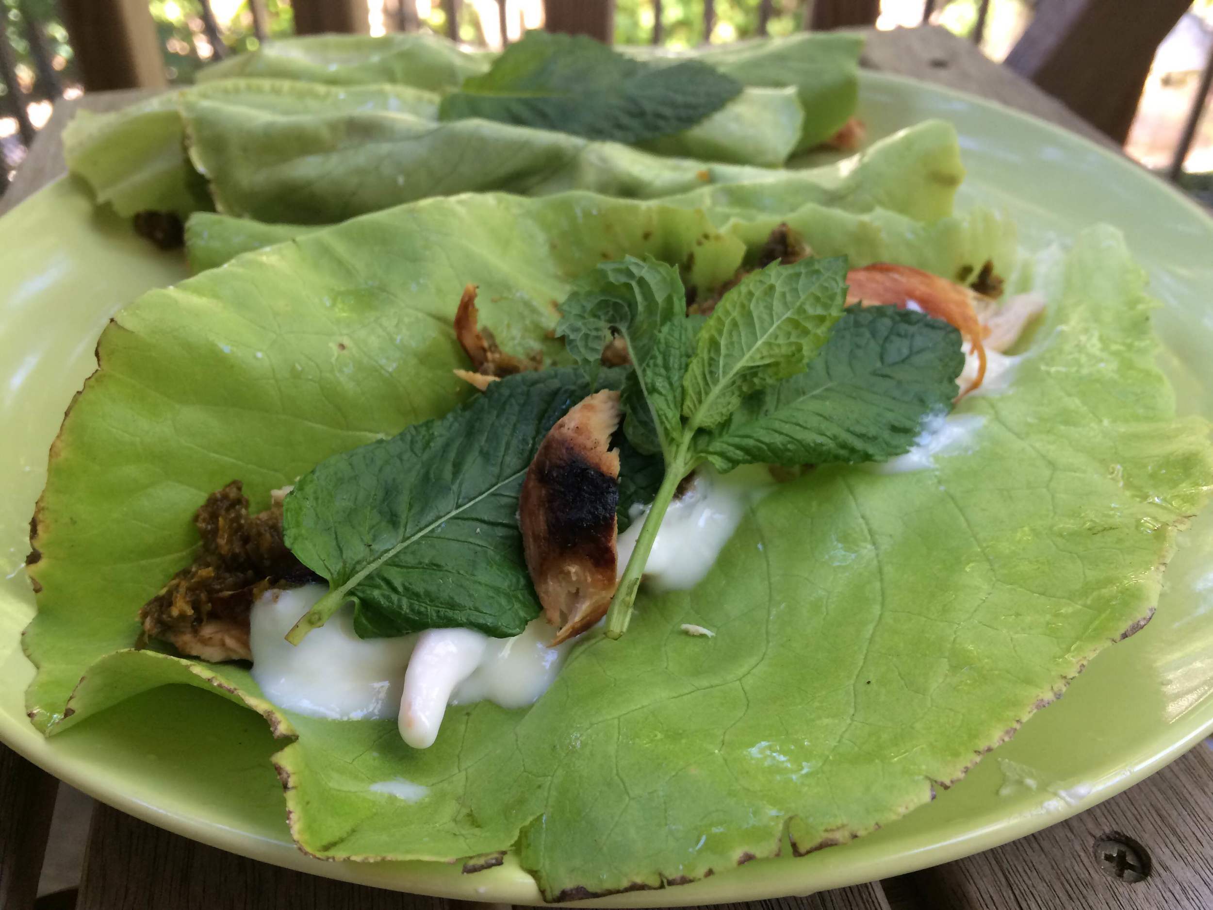 Lettuce wraps with grilled chicken, mustard green harissa, yogurt, and mint