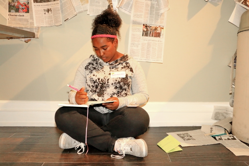 mentee writing in journal on floor.JPG