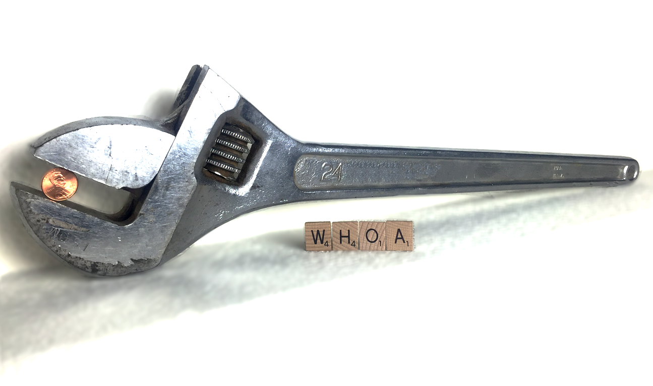 The Big Wrench with a penny and Scrabble letters for scale. 