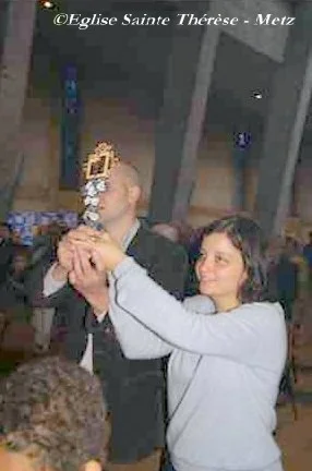 A couple carries the relics of the Martin spouses in the processional