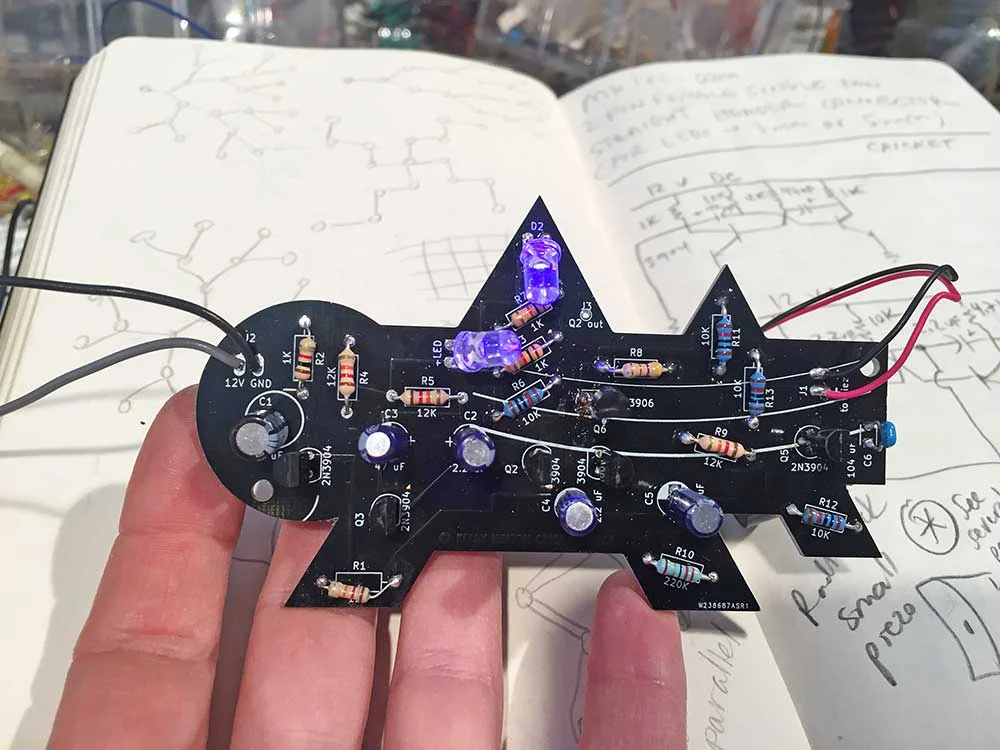 Astable multivibrator circuit built with discrete transistors. The circuit generates a waveform that sounds like a cricket when applied to a piezo electric buzzer. Kelly Heaton, 2018