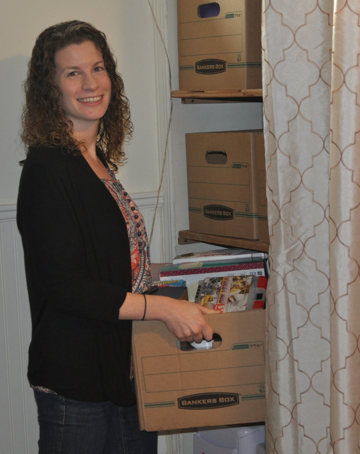Casey organizing boxes and making space for a client.