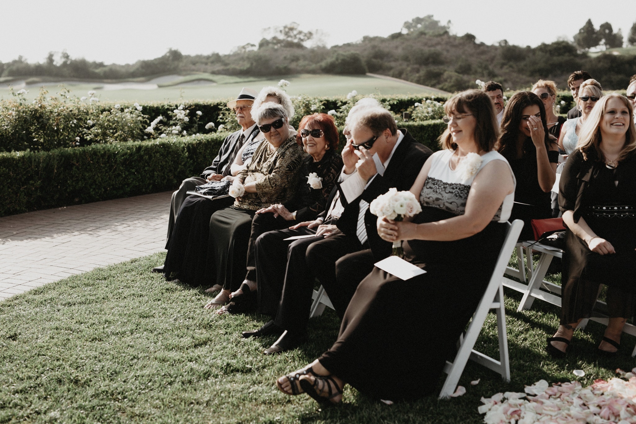Guests sit in the courtyard at The Resort at Pelican Hill during a wedding ceremony.