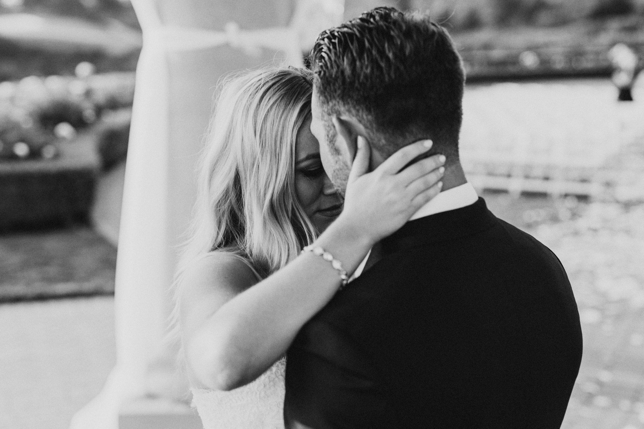 A bride and groom share an emotional and intimate moment while dancing at their Pelican Hill Resort wedding.