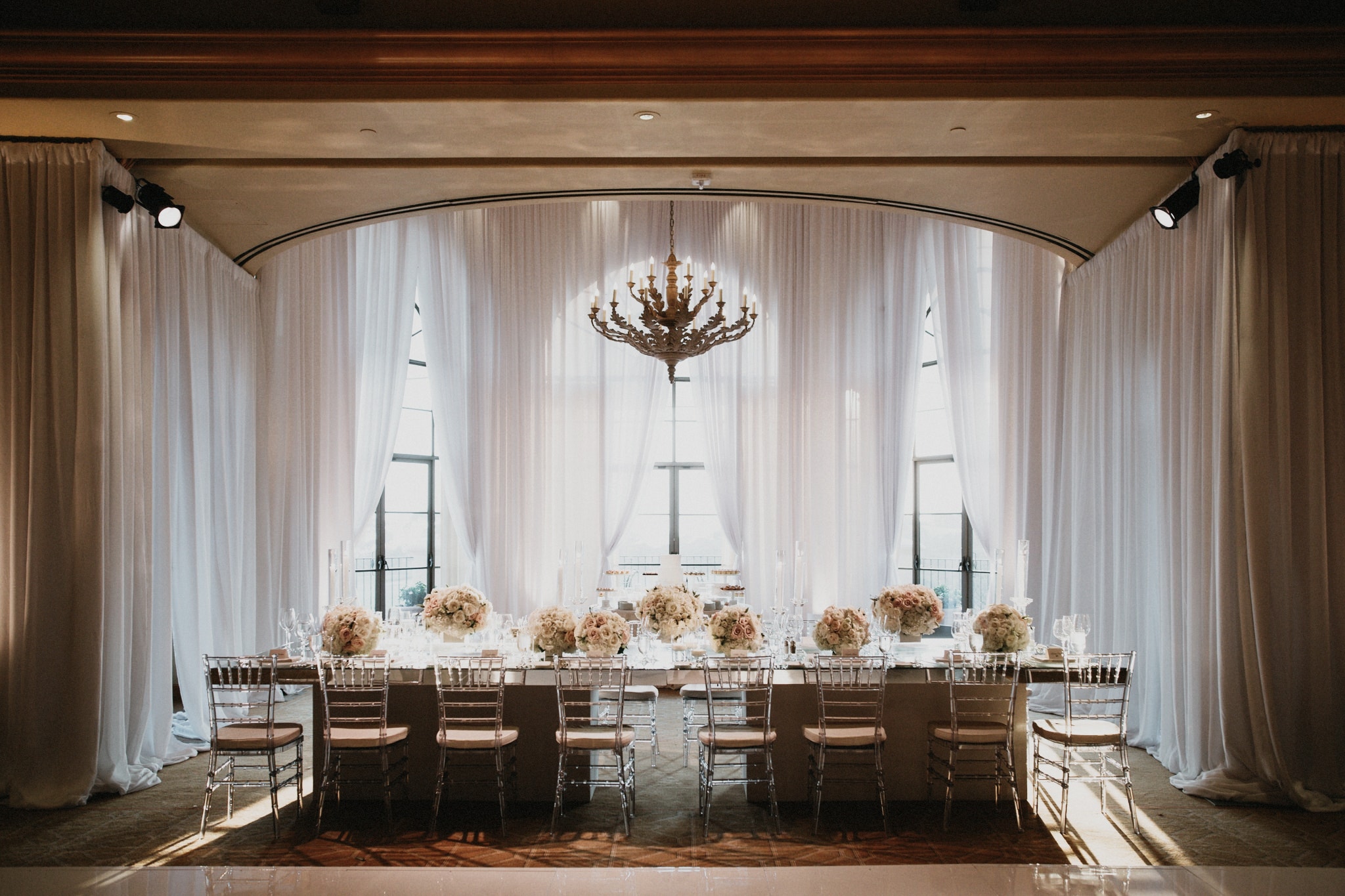 A long, beautifully set table awaiting dinner guests during a wedding at Pelican Hill Resort in Newport Beach.