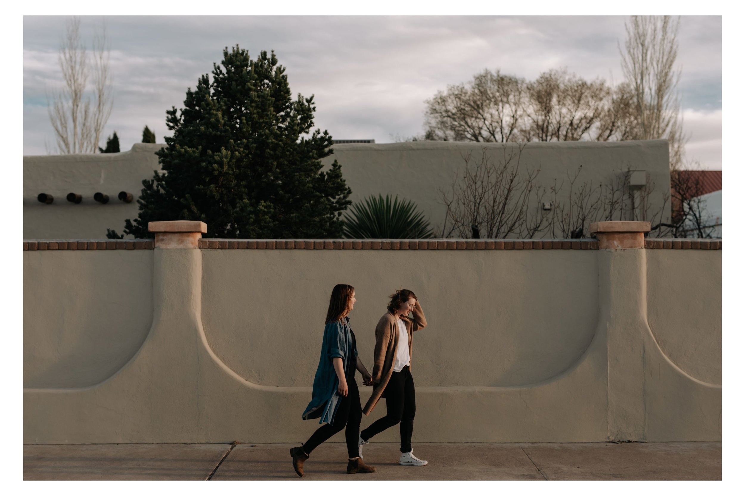 A couple walks hand-in-hand during an engagement shoot in Marfa, Texas with j.olson weddings.