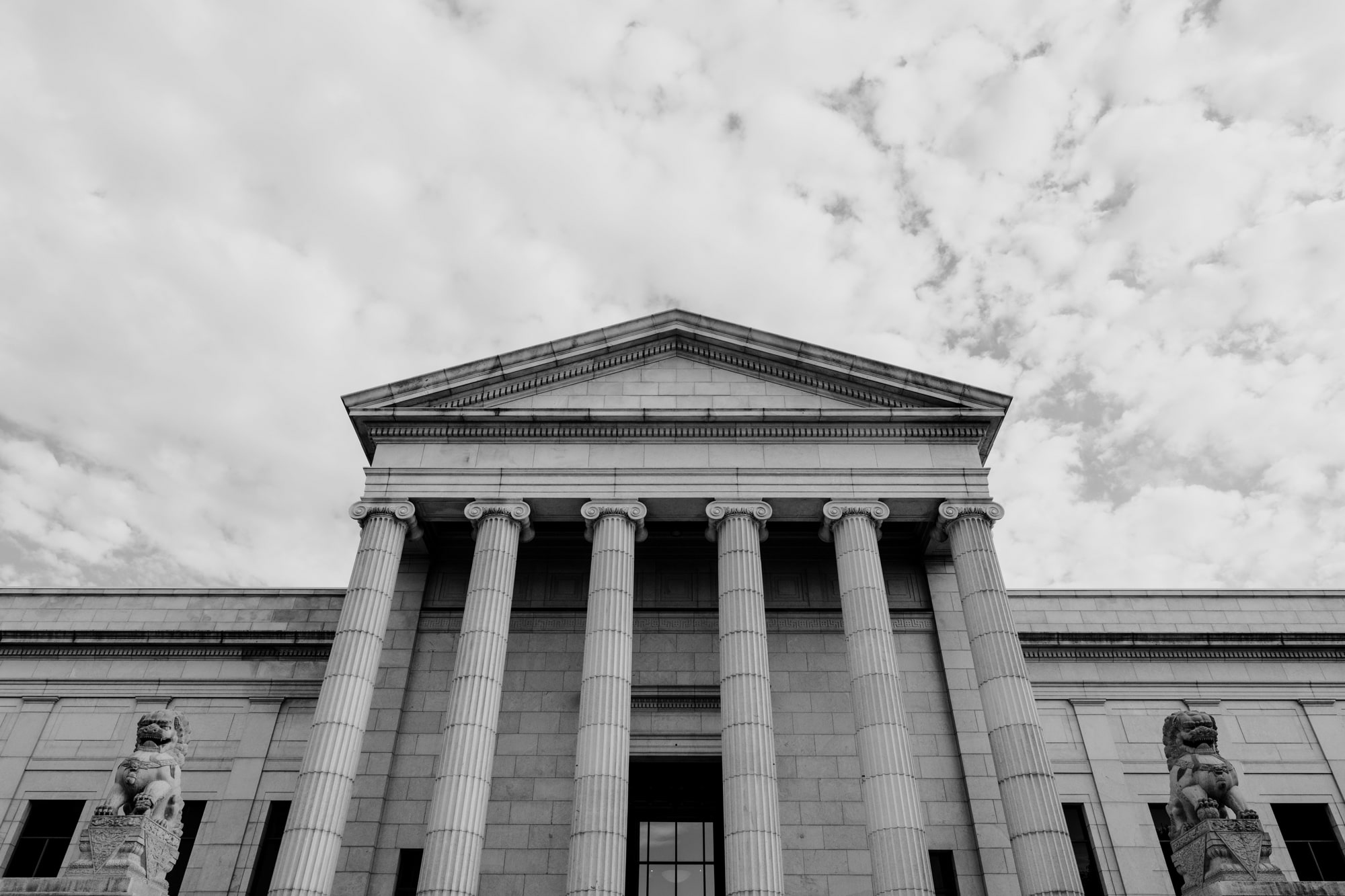 Outside of the entrance of the Minneapolis Institute of Art with impressive architecture and large columns.