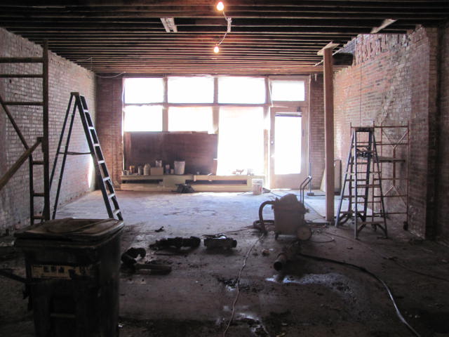 This shot shows the space right after the stairwell to the upstairs apartment was removed. It really opens up the front of the space.
