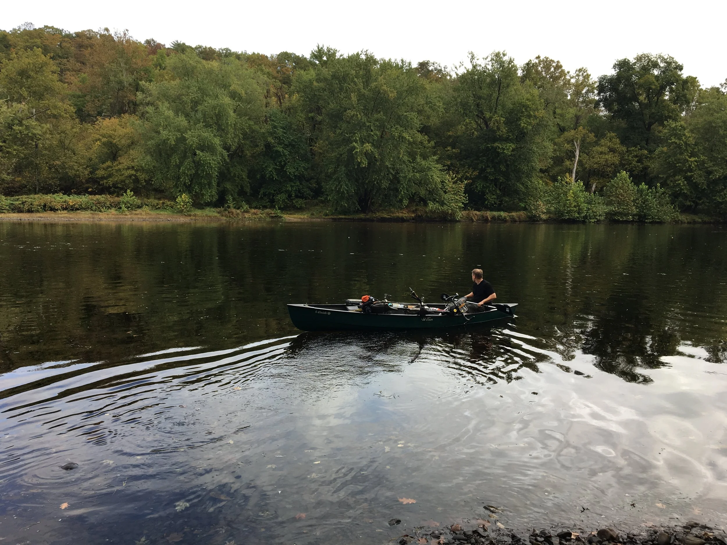 Paul works at Three Otters and here he is paddling the Tandem across the river.