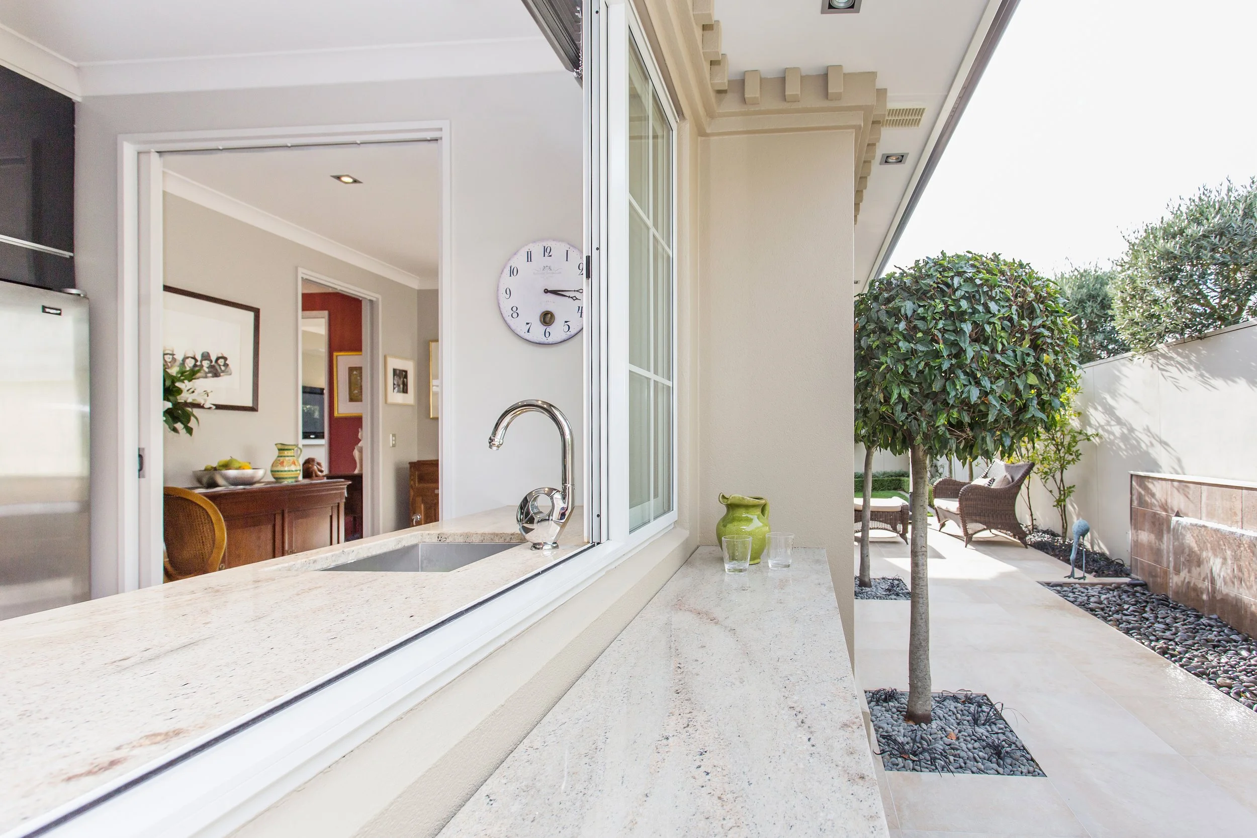 Indoor outdoor flow galley kitchen to exterior.