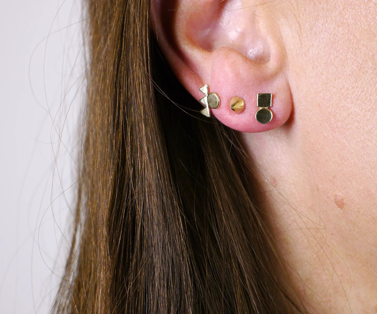 M triple triangle circle cone square circle studs.jpg