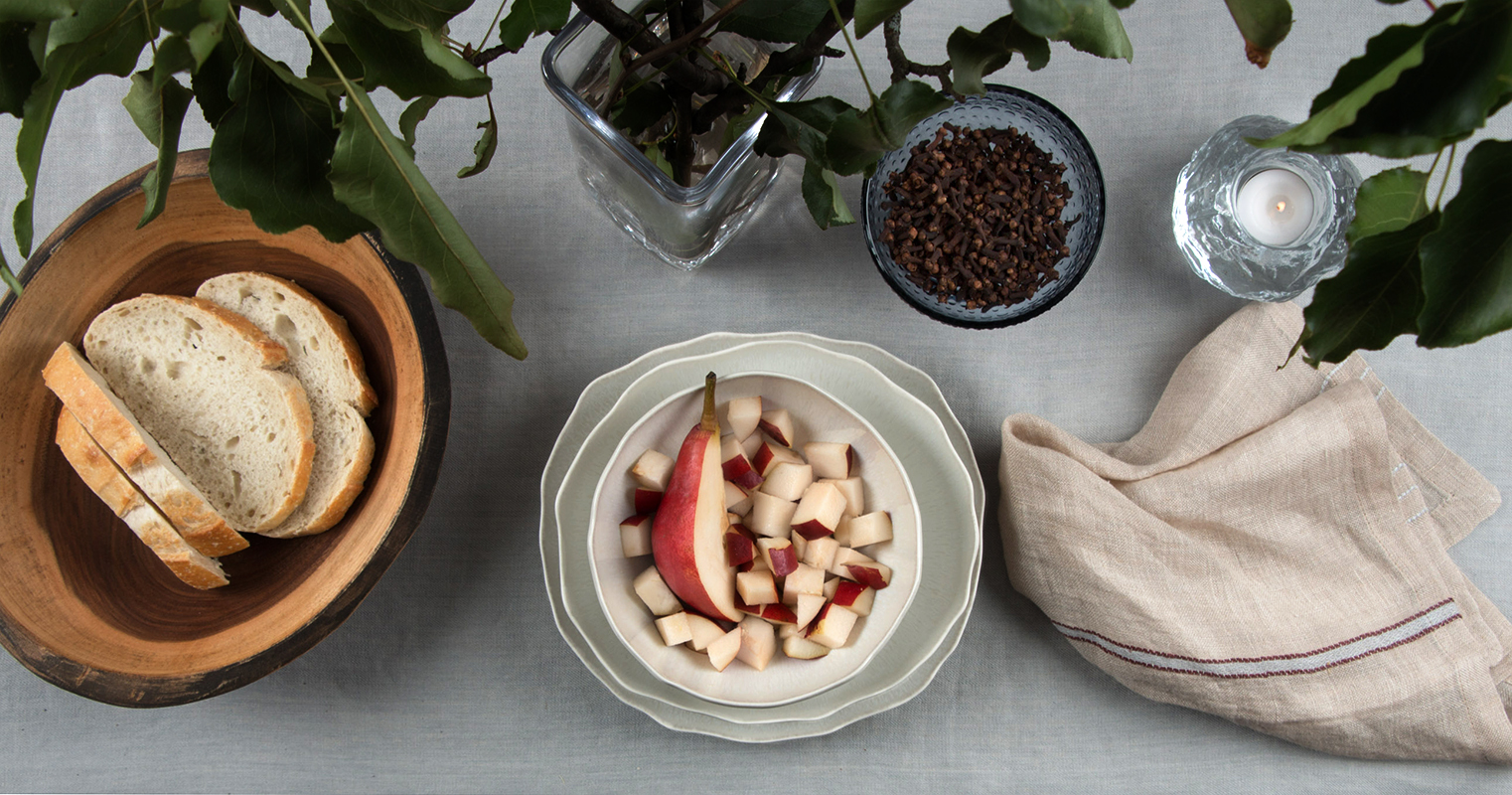   Jars Plume Dinnerware in White Pearl  ,  Simon Pearce Woodbury Vase  ,  Iittala Kastehelmi Dewdrop Footed Bowl  , Libeco Home Rya Napkin in Camel Stripe,  Spencer Peterman Oval Bowl in Cherry ,  Kosta Boda Snowball Votive  , Libeco Home Finn Tablec