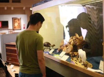 Attendees at the 2014 Design In Wood show at the Del Mar Fair admire the handiwork of many craftsmen and women.