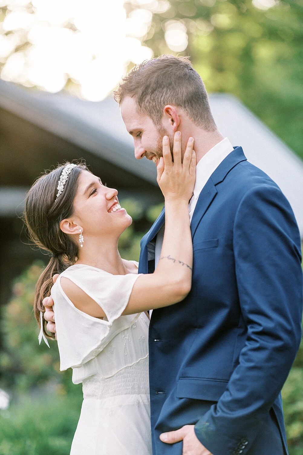 Soft hand on cheek and waist—romantic, natural touch.