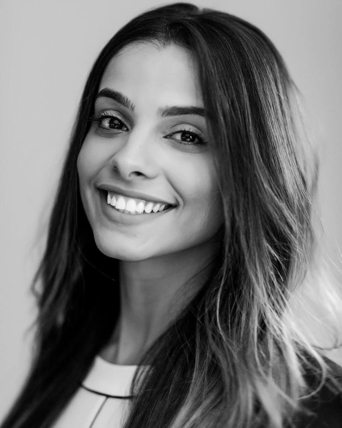 Editorial headshot with textured backdrop and fashion-forward styling