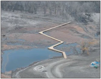 An aerial view showing the newly constructed 800-foot boardwalk across restored coastal wetland.